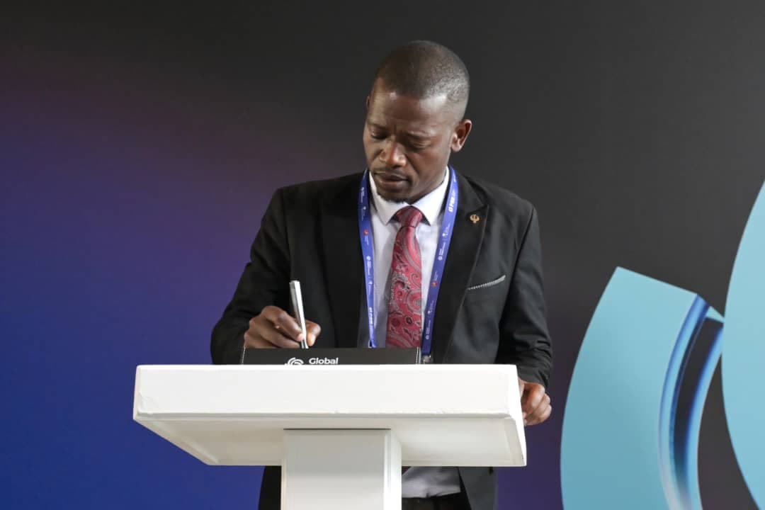 CODAZIM Founder Mussollini Mugumbate signing a memorandum of understanding at the Global Digital Forum